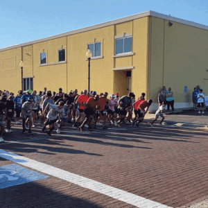 A group of people are walking down the street.