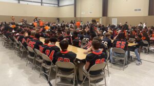 A group of people sitting around a table.