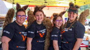 Four women in black shirts and furry animal ears.