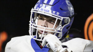 A man in blue and white football uniform with helmet.
