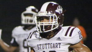 A football player wearing a helmet and uniform.