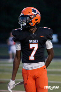 A football player in an orange and black uniform.