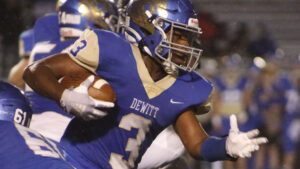 A football player running with the ball in his hand.