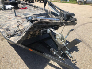 A large trailer with some parts missing on the ground