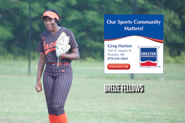 A woman in baseball uniform standing on top of a field.