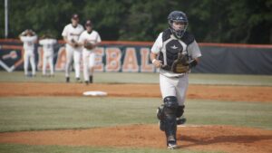A baseball player is walking on the field