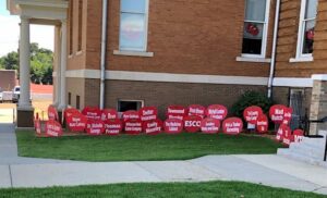 A lawn with many red signs on it